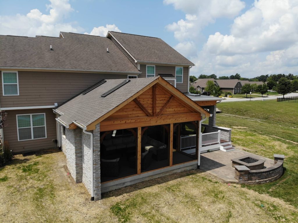 Rear view of 3-season patio with stone wall and porch