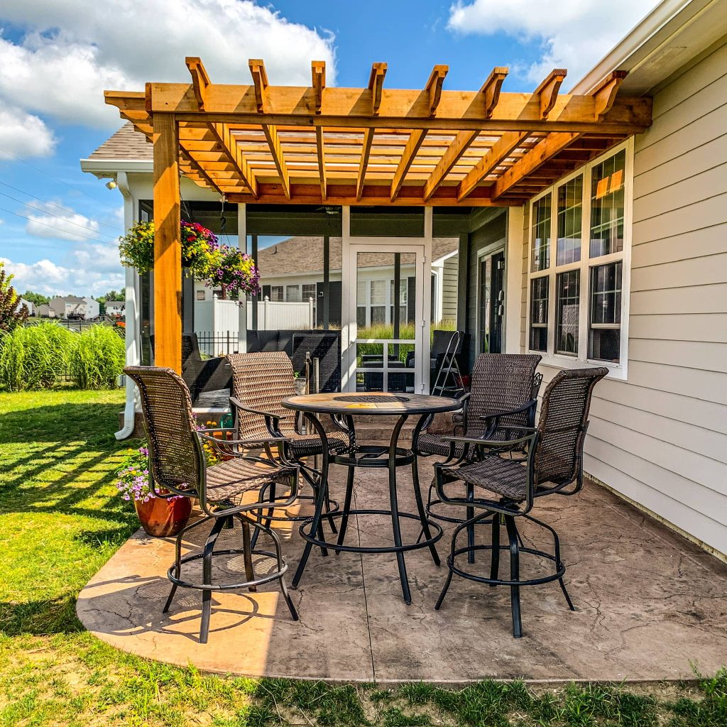 Concrete patio with a stamped stone look, blending seamlessly with the backyard landscape.