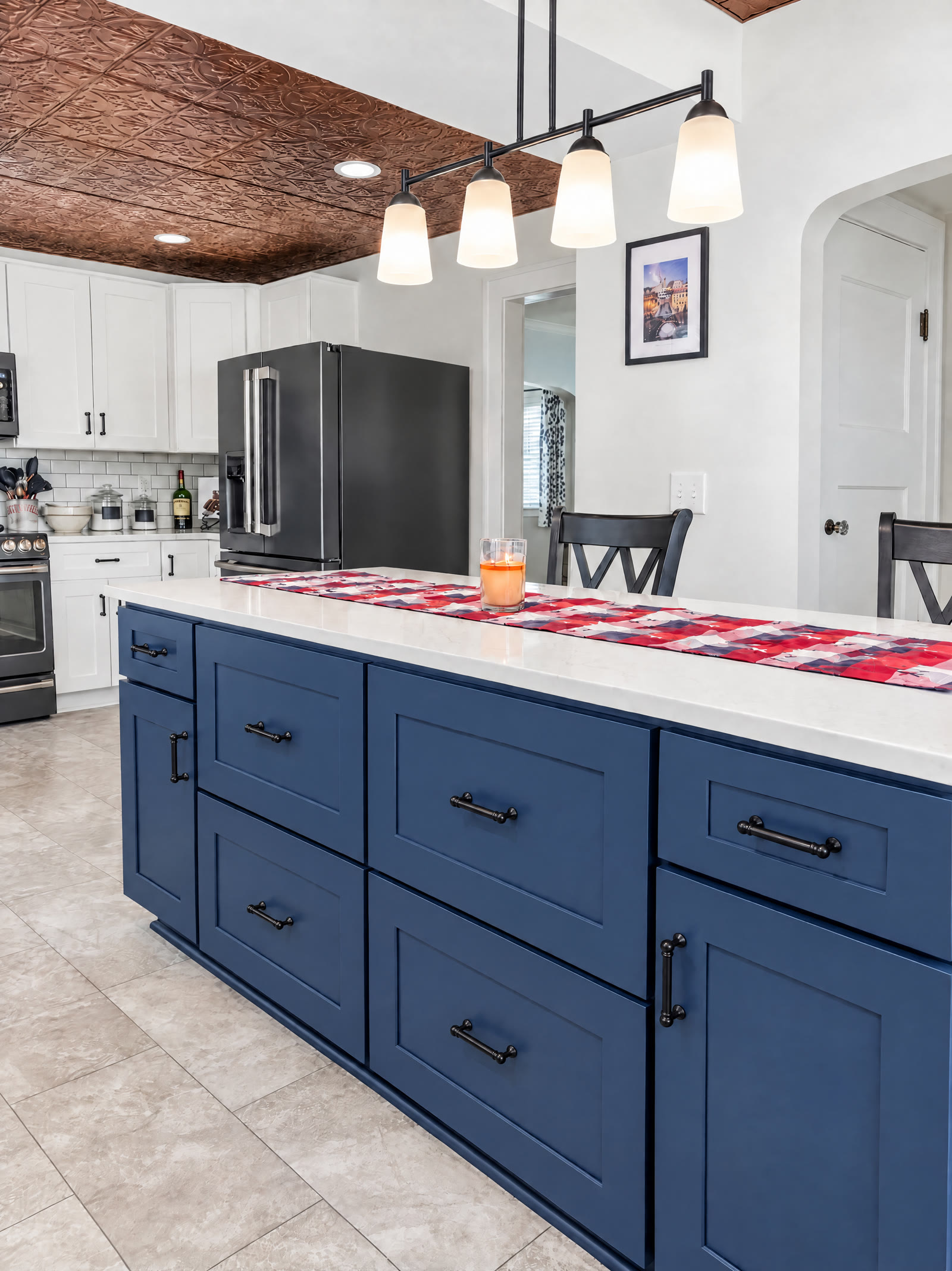 Large navy shaker island with quartz countertop in the renovated 1914 bungalow kitchen