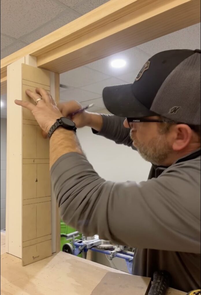 Bobby Williams of BGW Construction marking a measurement on the built-in bunk bed framing for the DCS safe space in Avon, Indiana