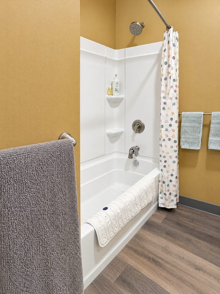 Bathtub and shower in the DCS safe space full bathroom, where a child can take a warm bath, remodeled by BGW Construction in Avon, Indiana