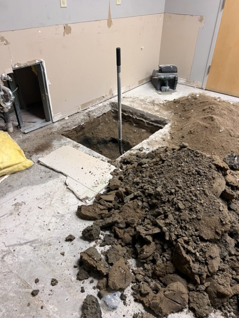 BGW Construction excavating through the concrete slab for new rough plumbing during the DCS safe space build at Kingsway Christian Church in Avon, Indiana