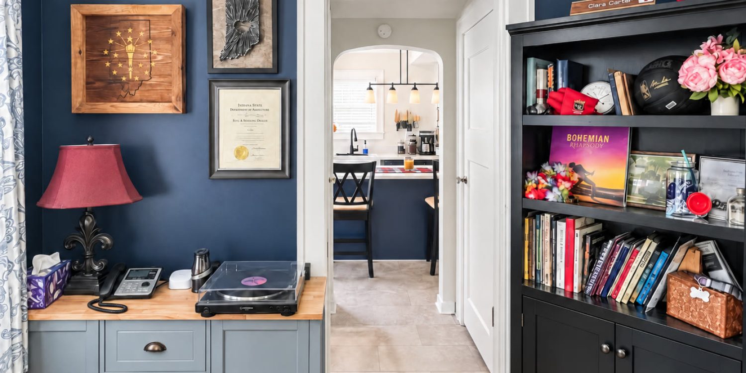 Preserved arched doorway connecting a navy home office to the renovated kitchen in a 1914 Stilesville bungalow