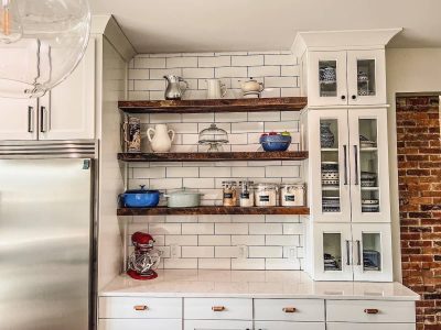 Open Shelving with White Cabinets and Subway Tile Backsplash Kitchen with open wooden shelves, white cabinetry, and subway tile backsplash